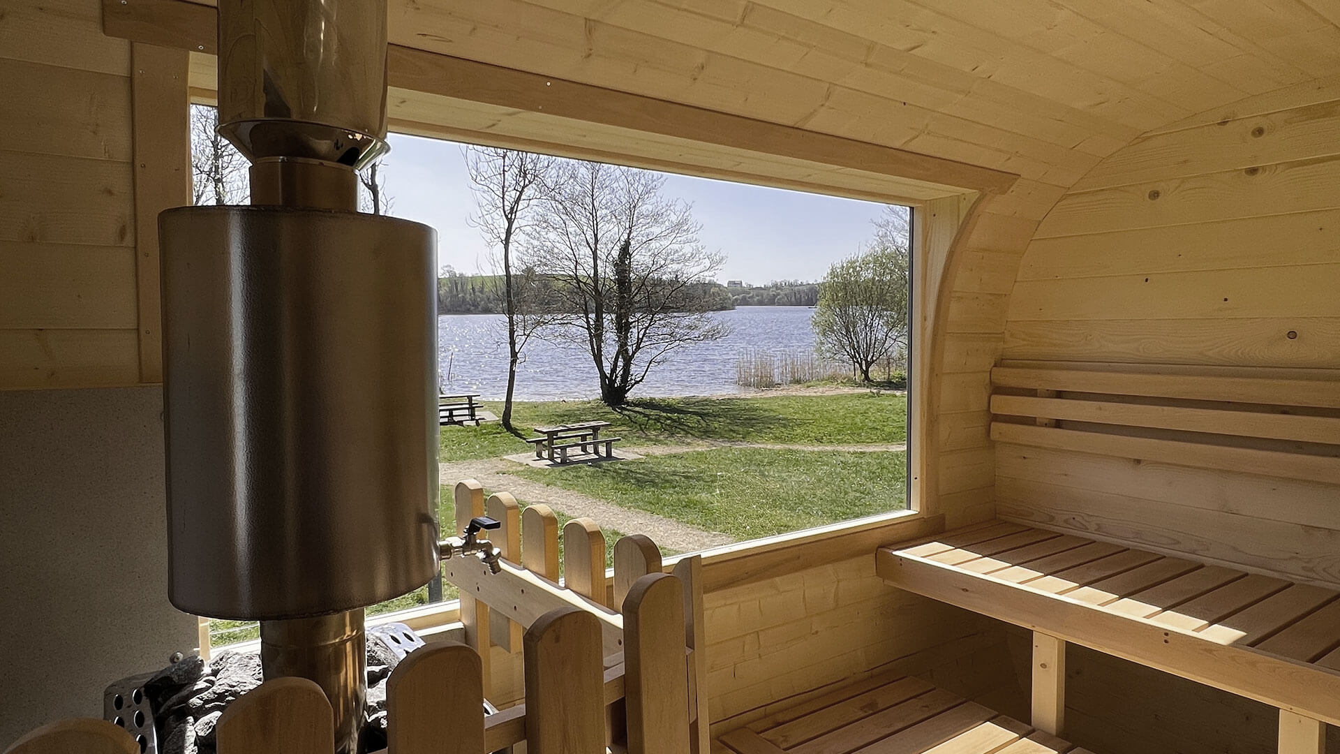Steam rising from a wood-fired sauna by a Cavan lake